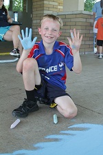 Young boy with Chalk on his hands