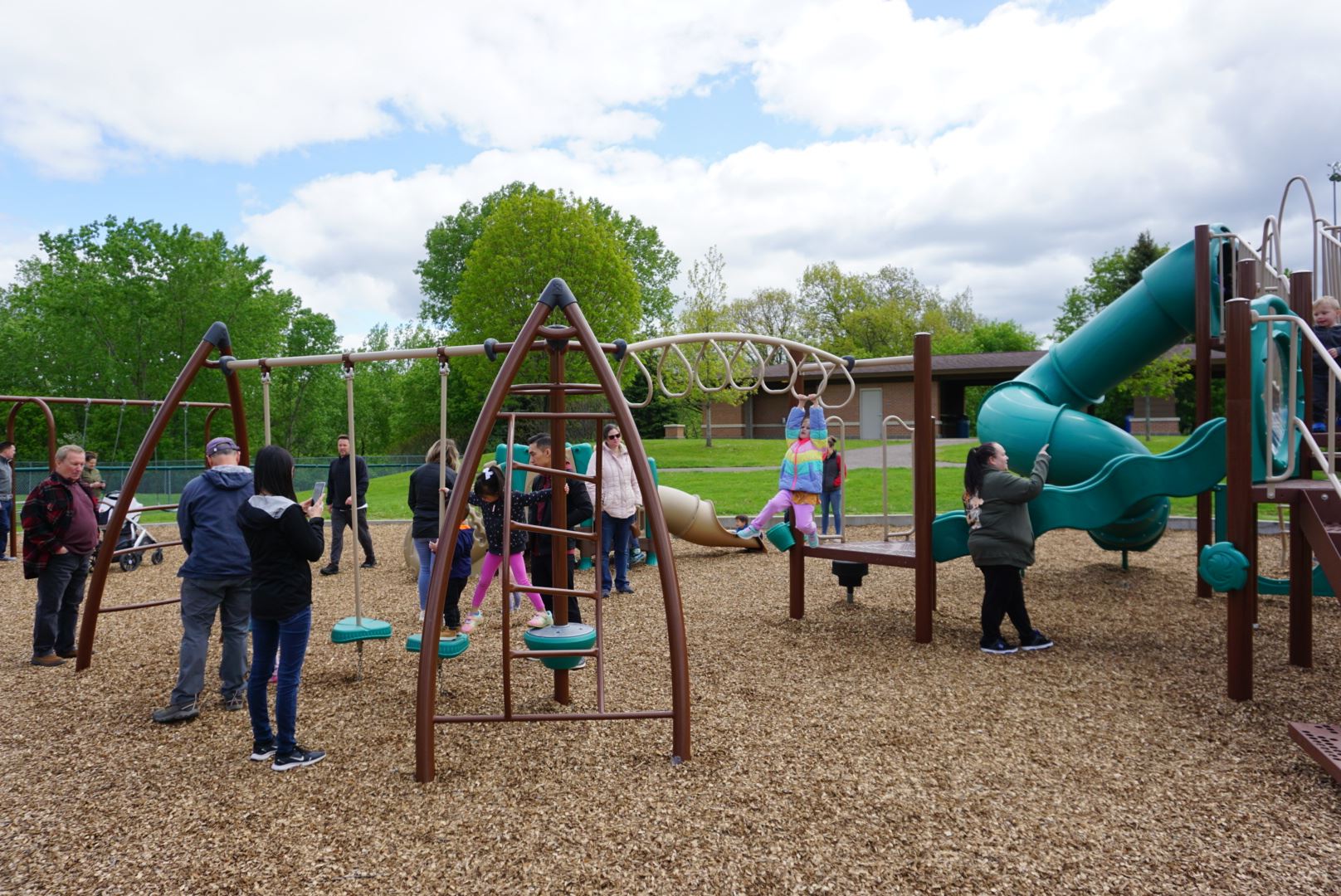 Kids and parents playing on the Perry Park Playground