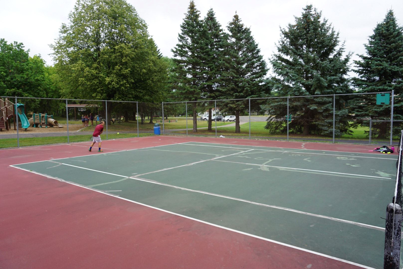 White man playing tennis at Hazelnut Park 