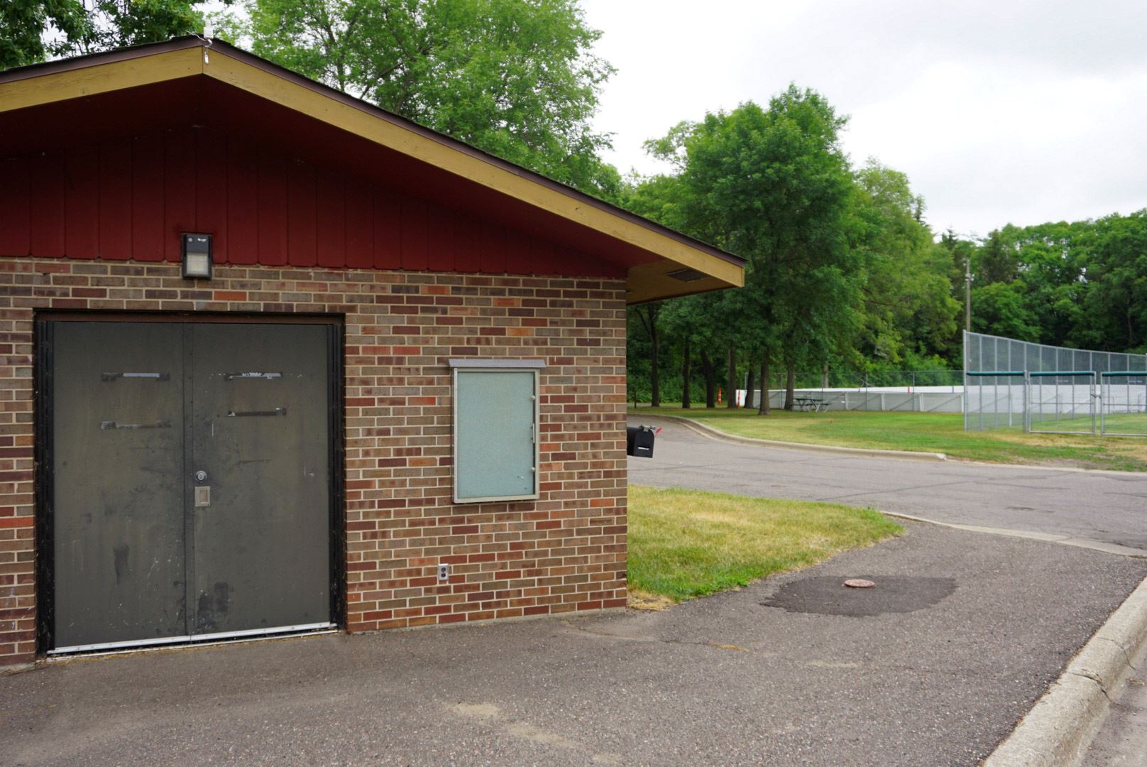Perry Park Warming House with Ice Rink in the Background in the Summertime