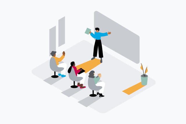 Classroom with three people sitting at desks and a teacher in the front of the room